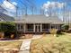Charming brick home featuring a covered porch, mature landscaping, and a stone walkway at 501 Colonels Ct, Clover, SC 29710