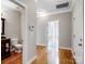 Hallway leading to various rooms, showcasing hardwood floors and neutral wall colors at 501 Colonels Ct, Clover, SC 29710