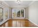 Bright living room featuring hardwood floors, large windows, and access to the outdoor porch at 501 Colonels Ct, Clover, SC 29710