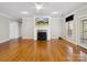 Bright living room with hardwood floors, a fireplace, and a ceiling fan at 501 Colonels Ct, Clover, SC 29710