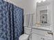 Bathroom with a shower, toilet, granite vanity, and a floral shower curtain providing a functional and stylish space at 5056 Blue Serenity Ct, Denver, NC 28037