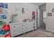 Bedroom featuring a dresser, decorations, and an adjacent doorway offering a comfortable atmosphere at 5056 Blue Serenity Ct, Denver, NC 28037