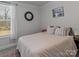 Bright bedroom featuring a neutral color scheme, comfortable bed, and a window with natural light at 5056 Blue Serenity Ct, Denver, NC 28037