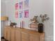 Stylish cabinet with six framed beverage prints, flowers and accent pieces at 5056 Blue Serenity Ct, Denver, NC 28037