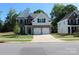 Charming two-story home with a two car garage, well-manicured lawn and neutral color scheme at 5056 Blue Serenity Ct, Denver, NC 28037