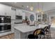 Bright, open kitchen with quartz countertops, modern appliances, and a cozy breakfast bar with seating at 5056 Blue Serenity Ct, Denver, NC 28037
