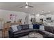 Inviting living room showcasing a plush leather sofa, neutral walls, and a seamless flow into the kitchen at 5056 Blue Serenity Ct, Denver, NC 28037