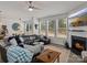 Bright living room with a fireplace, large sectional sofa, and views into the dining and kitchen areas at 5056 Blue Serenity Ct, Denver, NC 28037