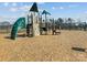 Community playground featuring climbing structures, slides, and a wood chip ground at 5056 Blue Serenity Ct, Denver, NC 28037