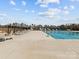 Community pool area featuring lounge chairs, a playground, and a swimming pool at 5056 Blue Serenity Ct, Denver, NC 28037