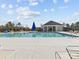 Community pool with clear water, pool furniture, and covered seating area at 5056 Blue Serenity Ct, Denver, NC 28037