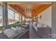 Cozy back porch features comfortable seating and scenic views of the lush backyard and lake at 5064 Lynwood Rd, Sherrills Ford, NC 28673