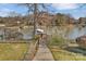 Path leading to a private dock on a lake, with lush greenery creating a private access to the water at 5064 Lynwood Rd, Sherrills Ford, NC 28673