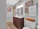 Well-lit bathroom with a stylish vanity, decorative mirror and organized towel storage at 5064 Lynwood Rd, Sherrills Ford, NC 28673