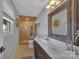 This bathroom features a stone walk-in shower, double vanity, and a large mirror at 5064 Lynwood Rd, Sherrills Ford, NC 28673