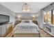 Spacious bedroom with tufted bench, pendant lighting, and a large window allowing natural light at 5064 Lynwood Rd, Sherrills Ford, NC 28673