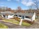 Inviting single-story home with a detached garage, featuring a well-manicured lawn and beautiful landscaping at 5064 Lynwood Rd, Sherrills Ford, NC 28673