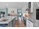 Kitchen with white cabinets, stainless steel appliances, and a brick accent wall leading to a blue door at 5064 Lynwood Rd, Sherrills Ford, NC 28673