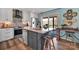 Modern kitchen with stainless steel appliances, island seating, and seamless access to the outdoor deck at 5064 Lynwood Rd, Sherrills Ford, NC 28673
