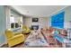 Open-concept living room with brick fireplace, plush seating, and a large window bringing in natural light at 5064 Lynwood Rd, Sherrills Ford, NC 28673
