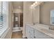 Bright bathroom featuring a double sink vanity, tile floors, and walk-in shower with glass door at 530 Silers Bald Dr, Fort Mill, SC 29715