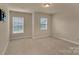 Bright bedroom with neutral carpet and two windows providing plenty of natural light at 530 Silers Bald Dr, Fort Mill, SC 29715
