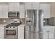 Bright kitchen featuring stainless steel appliances and white cabinets at 530 Silers Bald Dr, Fort Mill, SC 29715