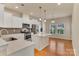 Modern kitchen features white cabinets, an island, stainless steel appliances, and hardwood floors at 530 Silers Bald Dr, Fort Mill, SC 29715