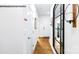 Bright hallway with hardwood floors, stylish mirror, and white doors at 535 Trading Post Ln, York, SC 29745