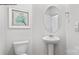 Powder room featuring a pedestal sink, oval mirror, and wall art for a clean and stylish design at 537 Trading Post Ln, York, SC 29745