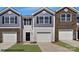 Charming townhouse with two-tone siding, stone accents, and a one-car garage with driveway at 537 Trading Post Ln, York, SC 29745
