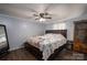 Inviting bedroom featuring dark furniture, ceiling fan, and laminate flooring at 5448 Bill Sain Rd, Vale, NC 28168