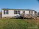 Charming home with vinyl siding, stone accent, and a welcoming front deck at 5448 Bill Sain Rd, Vale, NC 28168