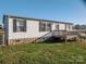 Charming home with vinyl siding, stone accent, and a welcoming front deck at 5448 Bill Sain Rd, Vale, NC 28168