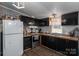 Efficient kitchen with dark cabinets, ample counter space, and modern appliances at 5448 Bill Sain Rd, Vale, NC 28168