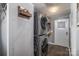 Convenient laundry room equipped with stacked washer and dryer, and wall storage with a gray walls at 5448 Bill Sain Rd, Vale, NC 28168