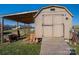 View of shed with wooden door and awning with wooden ramp at 5448 Bill Sain Rd, Vale, NC 28168