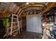 Well-organized storage building with wooden beams, shelving, and an insulated ceiling at 5448 Bill Sain Rd, Vale, NC 28168