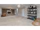 Spacious finished basement with brick fireplace, neutral walls, and carpeted floors at 601 Highland Forest Dr, Charlotte, NC 28270