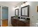 Bathroom with granite-top dual vanity offering elegance and functionality with well-lit mirrors at 601 Highland Forest Dr, Charlotte, NC 28270