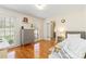 Cozy bedroom featuring hardwood floors, large windows, and tranquil ambiance at 601 Highland Forest Dr, Charlotte, NC 28270