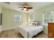 Cozy bedroom with a full-size bed, ceiling fan, and natural light streaming through the window at 601 Highland Forest Dr, Charlotte, NC 28270