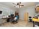 Spacious bedroom with ceiling fan, wood floors, and two large windows for natural light at 601 Highland Forest Dr, Charlotte, NC 28270