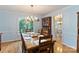 Dining room featuring hardwood floors, light-blue walls, and dining table with six chairs under a decorative chandelier at 601 Highland Forest Dr, Charlotte, NC 28270