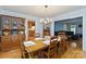 A dining room is adjacent to the living room, featuring blue walls, hardwood floors, and a wood hutch at 601 Highland Forest Dr, Charlotte, NC 28270