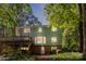 Home exterior with a wood deck, brick foundation, and bay windows at 601 Highland Forest Dr, Charlotte, NC 28270