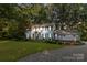 Charming two-story home with light-blue siding, black shutters, and a well-manicured front lawn and garden at 601 Highland Forest Dr, Charlotte, NC 28270