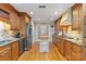 Spacious kitchen featuring wood cabinets, granite countertops, stainless steel appliances, and a center island at 601 Highland Forest Dr, Charlotte, NC 28270
