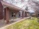 Landscaped backyard featuring a covered porch, well-maintained lawn, and a small garden area at 6200 Summertree Ln, Charlotte, NC 28226