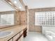 Bathroom featuring a vanity, wallpaper, and glass block windows at 6200 Summertree Ln, Charlotte, NC 28226